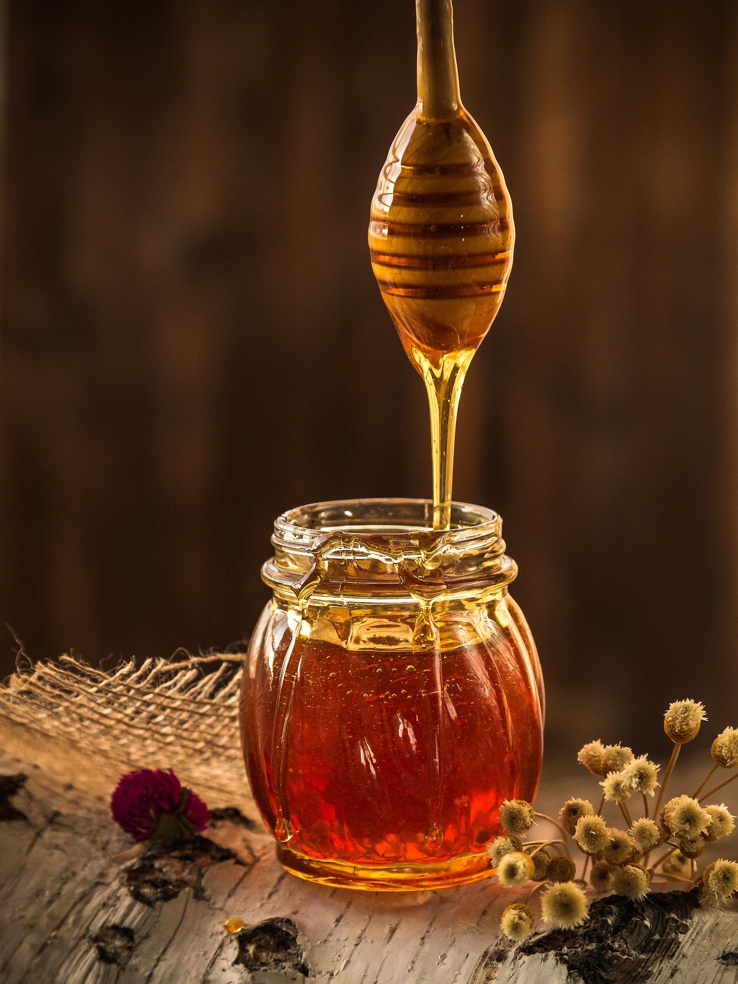 honey dripping into a jar