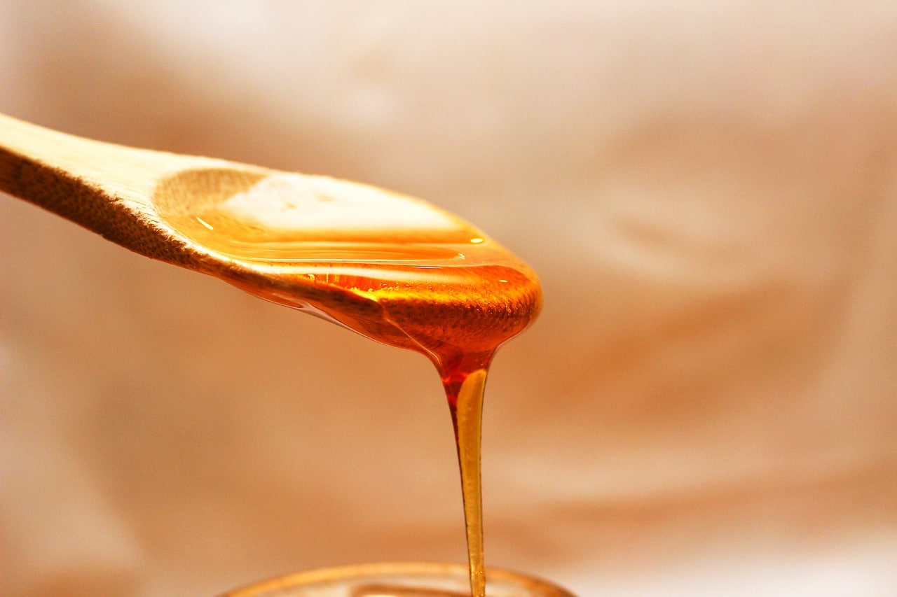 honey dripping from a spoon